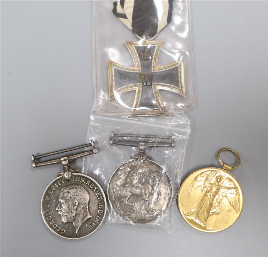 A German Iron Cross together with two British WWI medals and a Victory medal